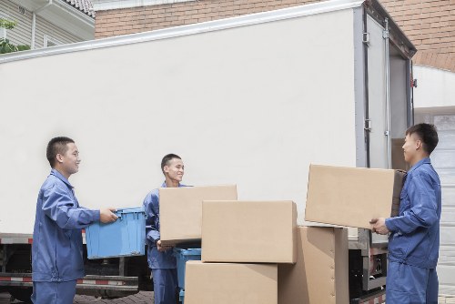 Professional man and van loading items for a St Johns Wood move