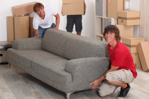 Loading furniture and boxes into a removal truck in NW8